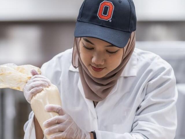 Ohio State Student Icing Cookies